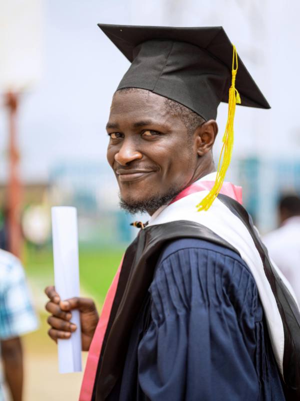Graduated Student wearing dark-blue mortar and graduation gown