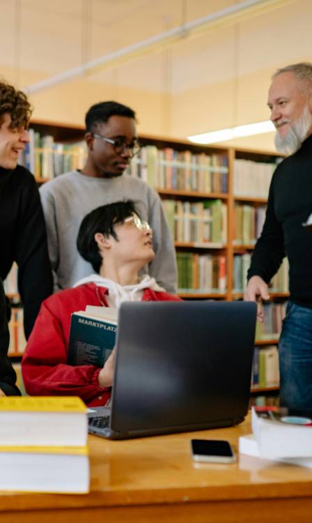 Students in the library with their lecturer learning