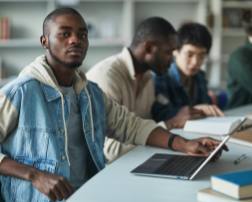 Two black students and white student in a class